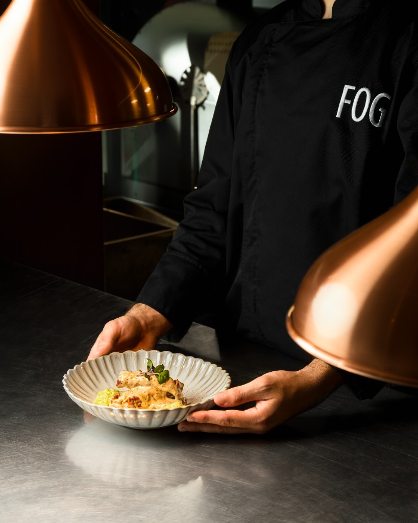 Chef presenting a plated dish