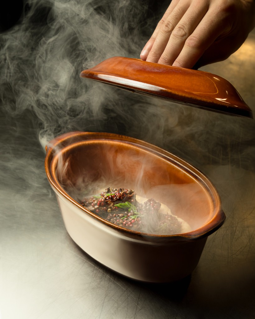 Steaming dish being uncovered